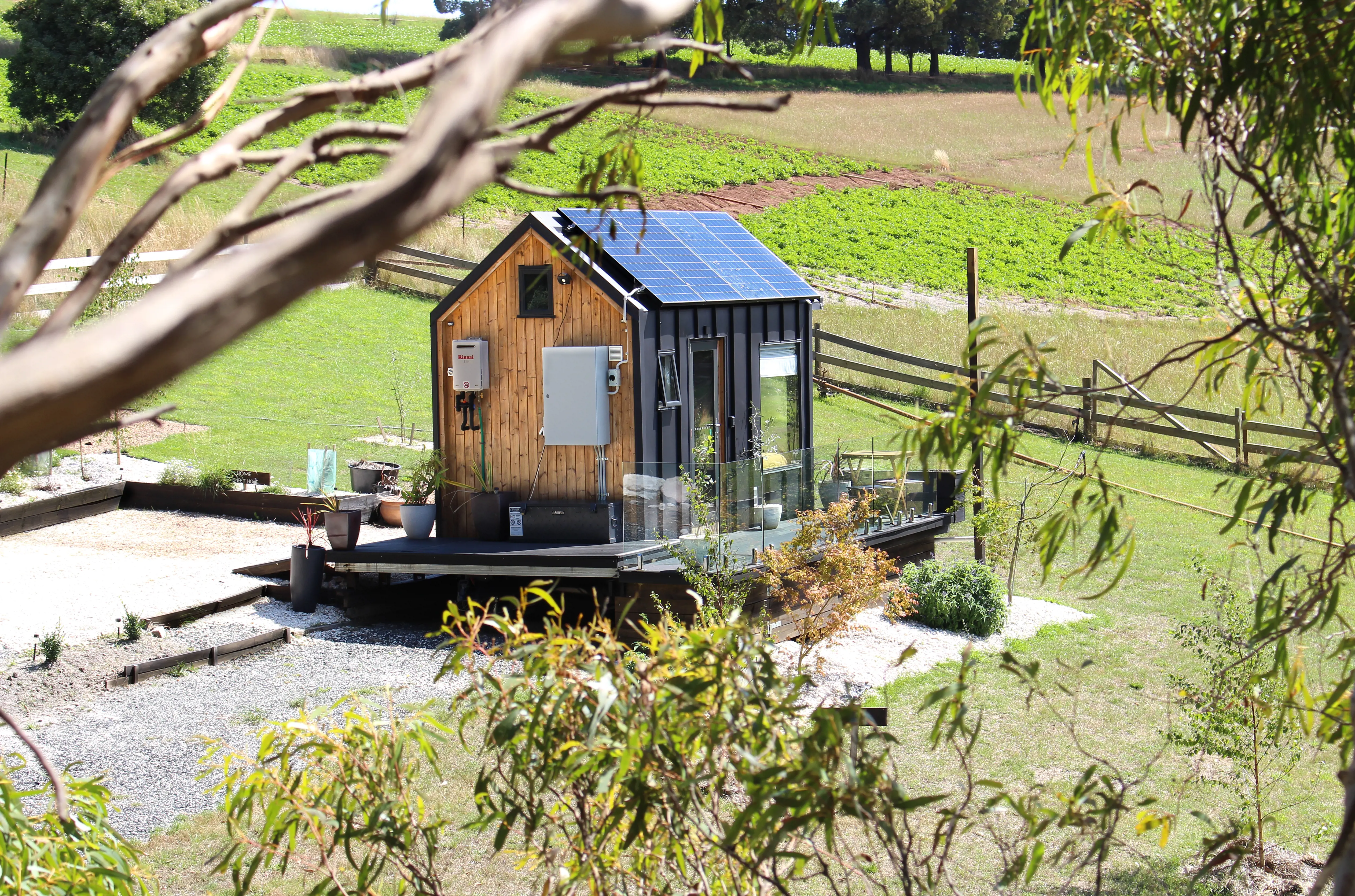 Shot of the self sustaining modern Compass Hut, taken from among the gum trees.