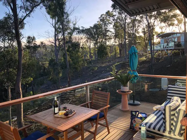 Exterior shot of Free Spirit Pods on Bruny Island, Showcasing its beautiful deck in its wild location.
