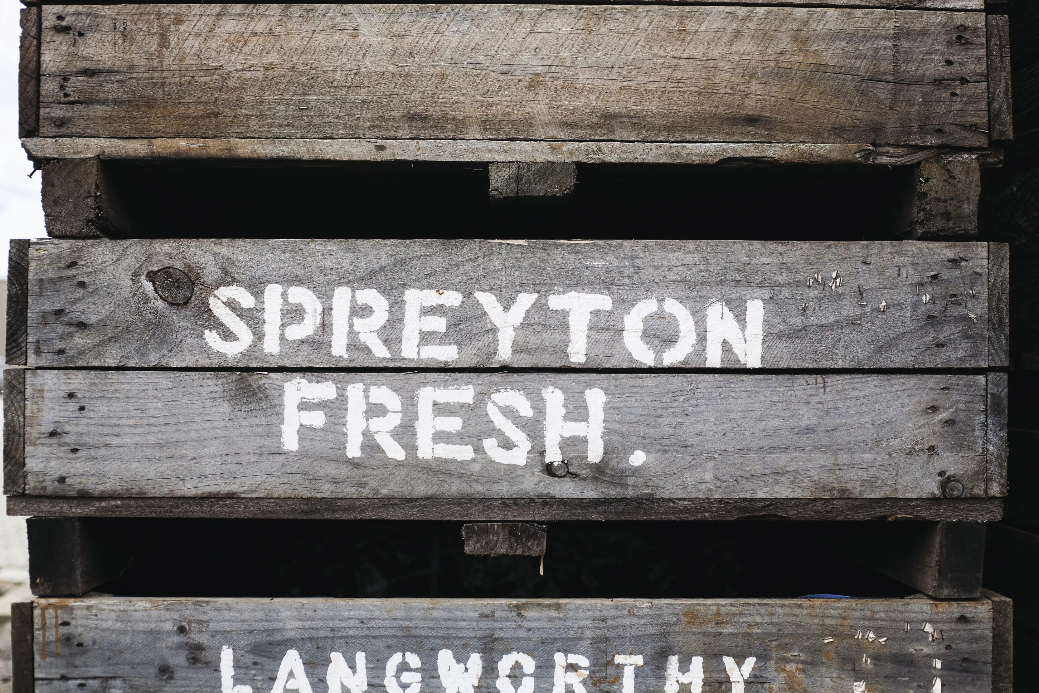 Spreyton Fresh signage painted on wooden panels.