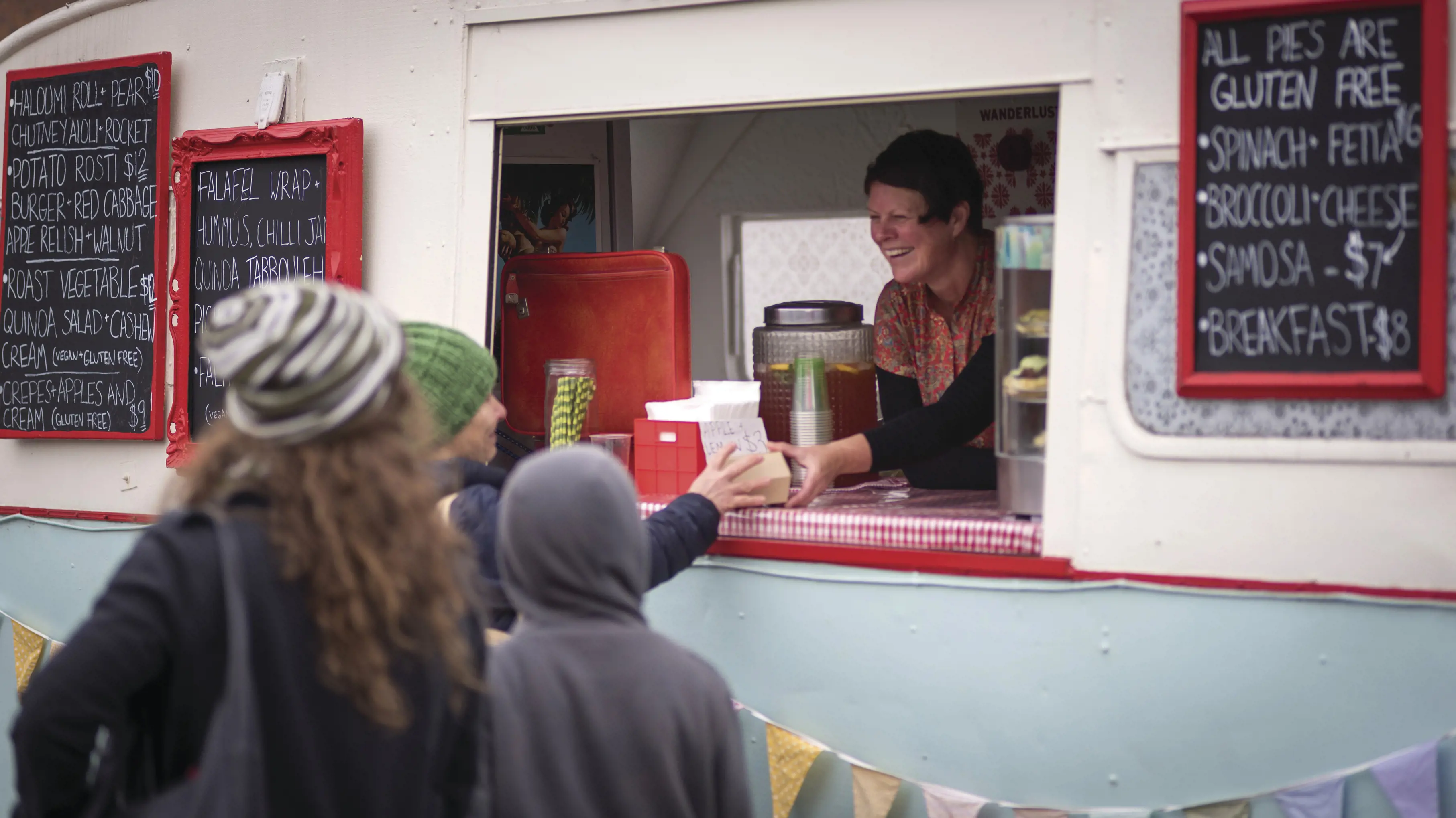 A man purchasing food at Harvest Launceston Farmers' Market