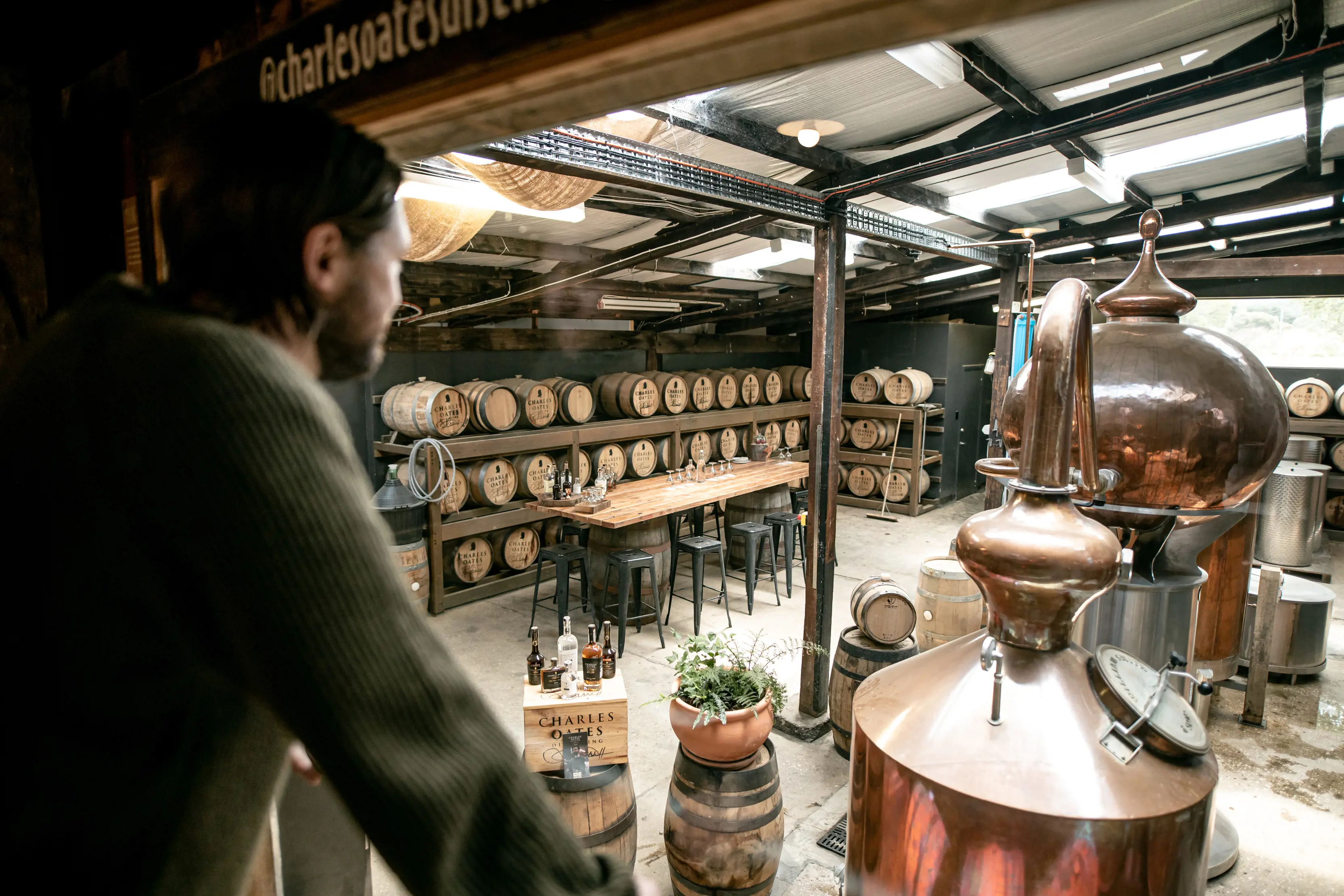 Man looking into the Charles Oates Distillery, Located in Willie Smith's Apple Shed.