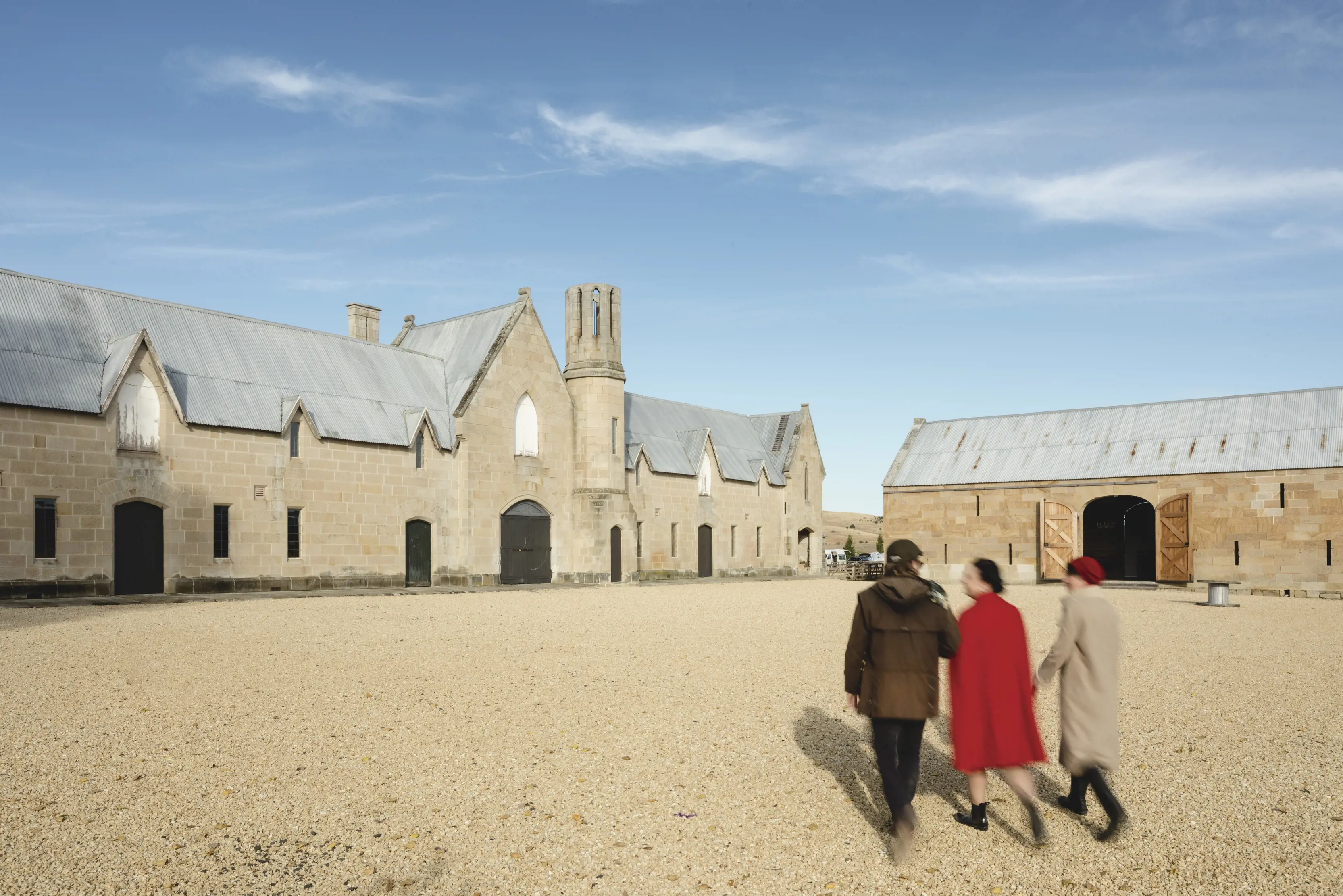 Friends walk through the centre of Shene Estate, a historic property with a distillery, at Pontville.