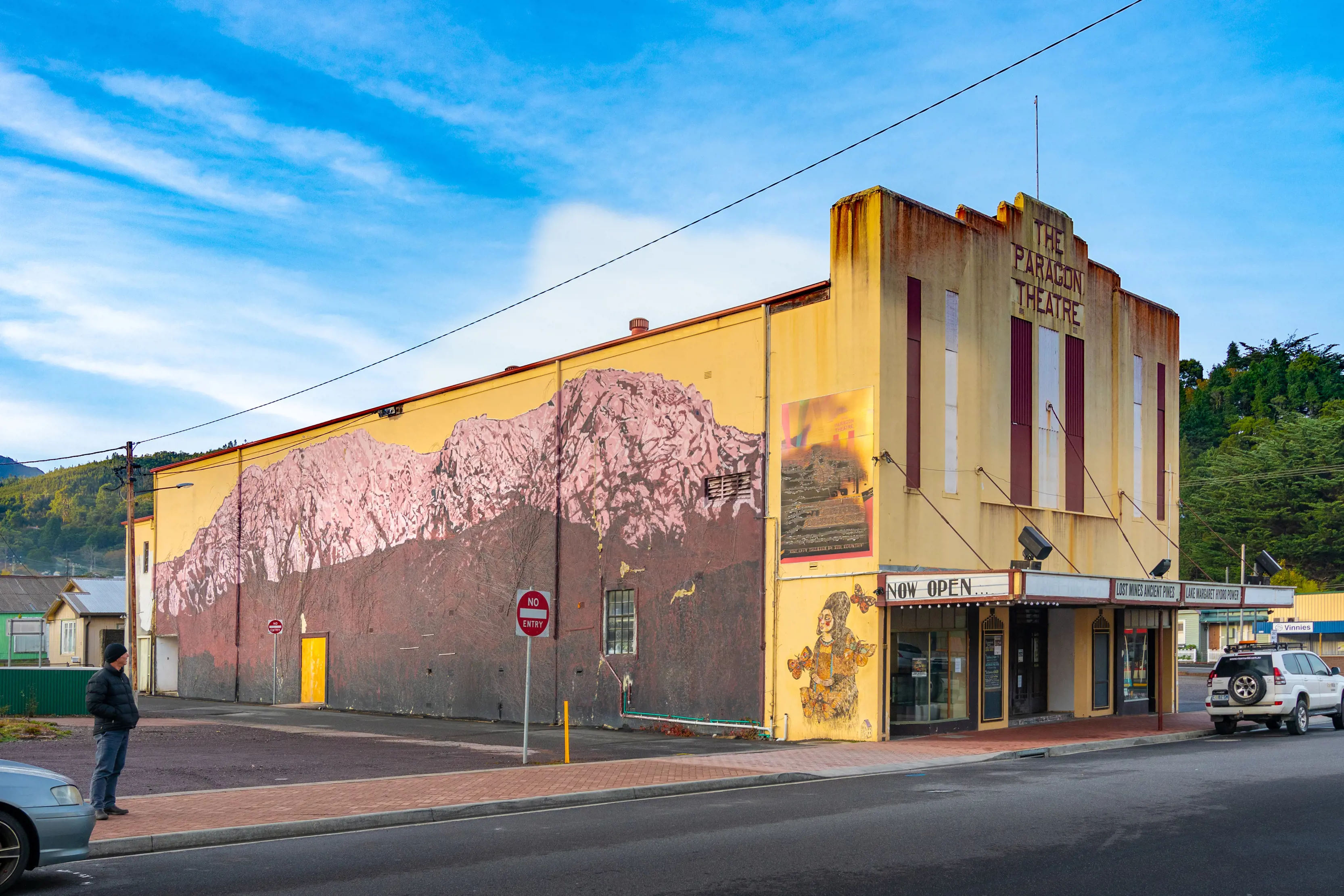 Exterior of a man looking at the street art at The Paragon Theatre, Queenstown.