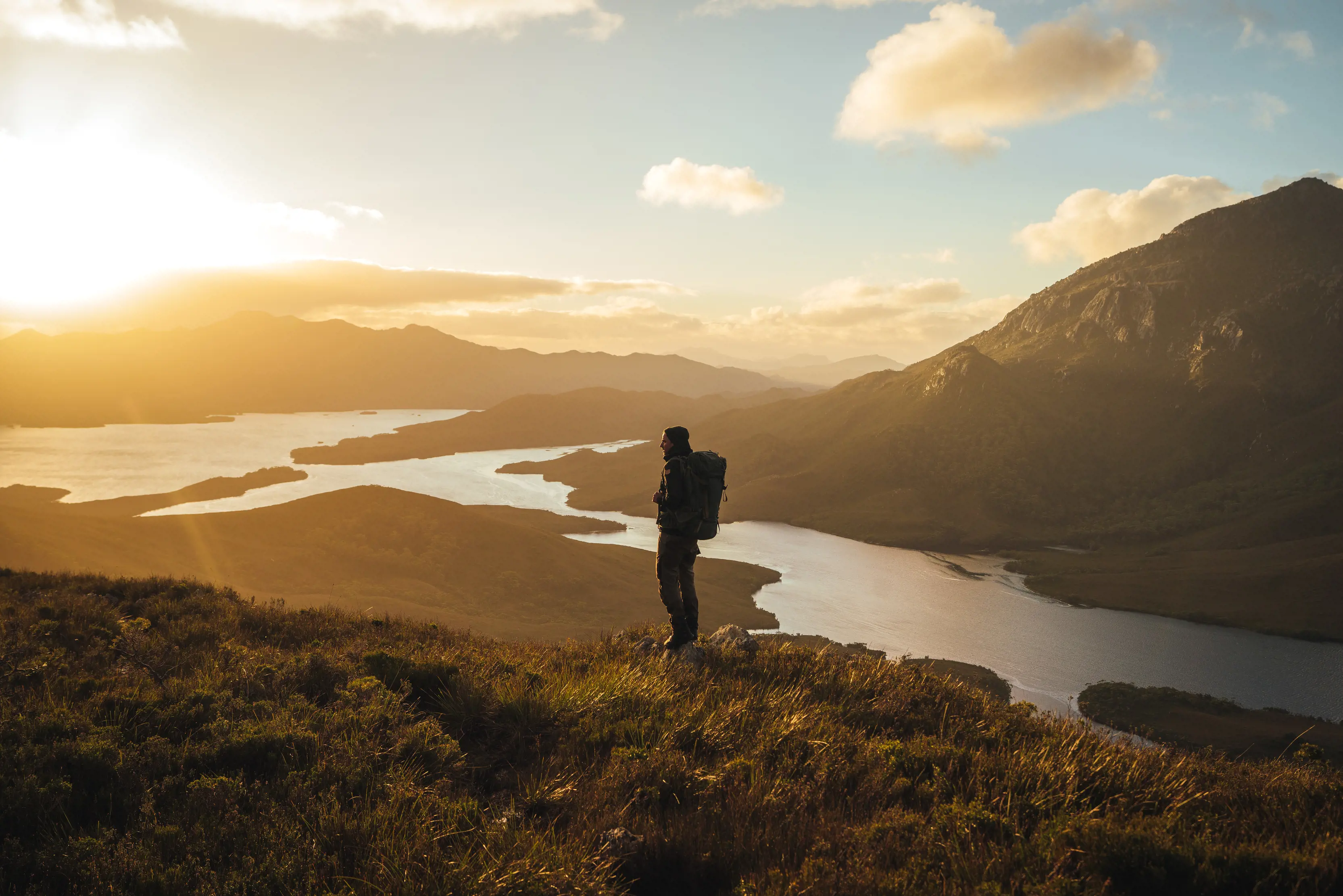 Hiker standing in the foreground, Bathurst Harbour, Southwest National Park.