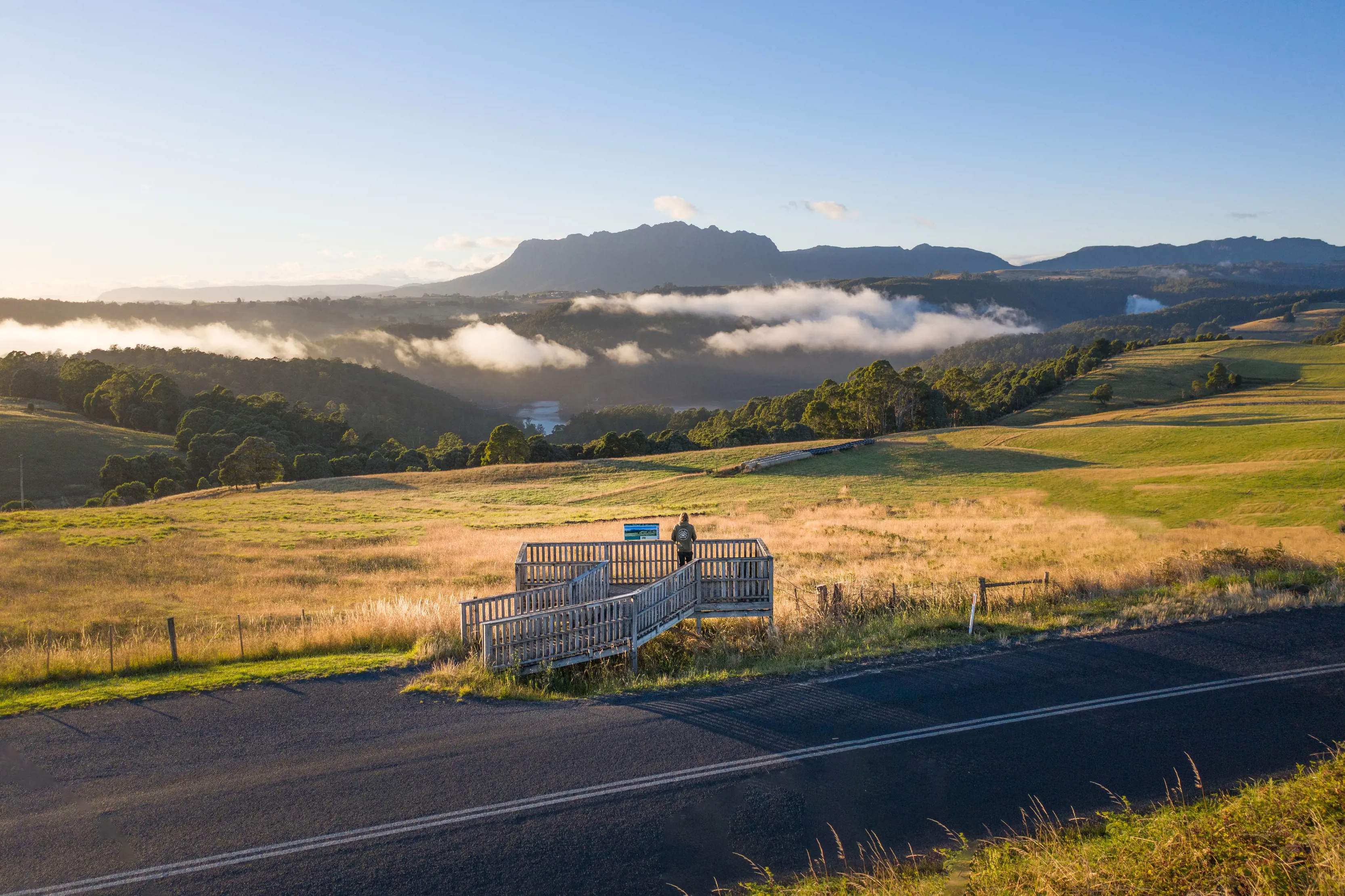 Spectacular image of a person viewing Mt Roland from a lookout at Wilmot, captured on sunrise.