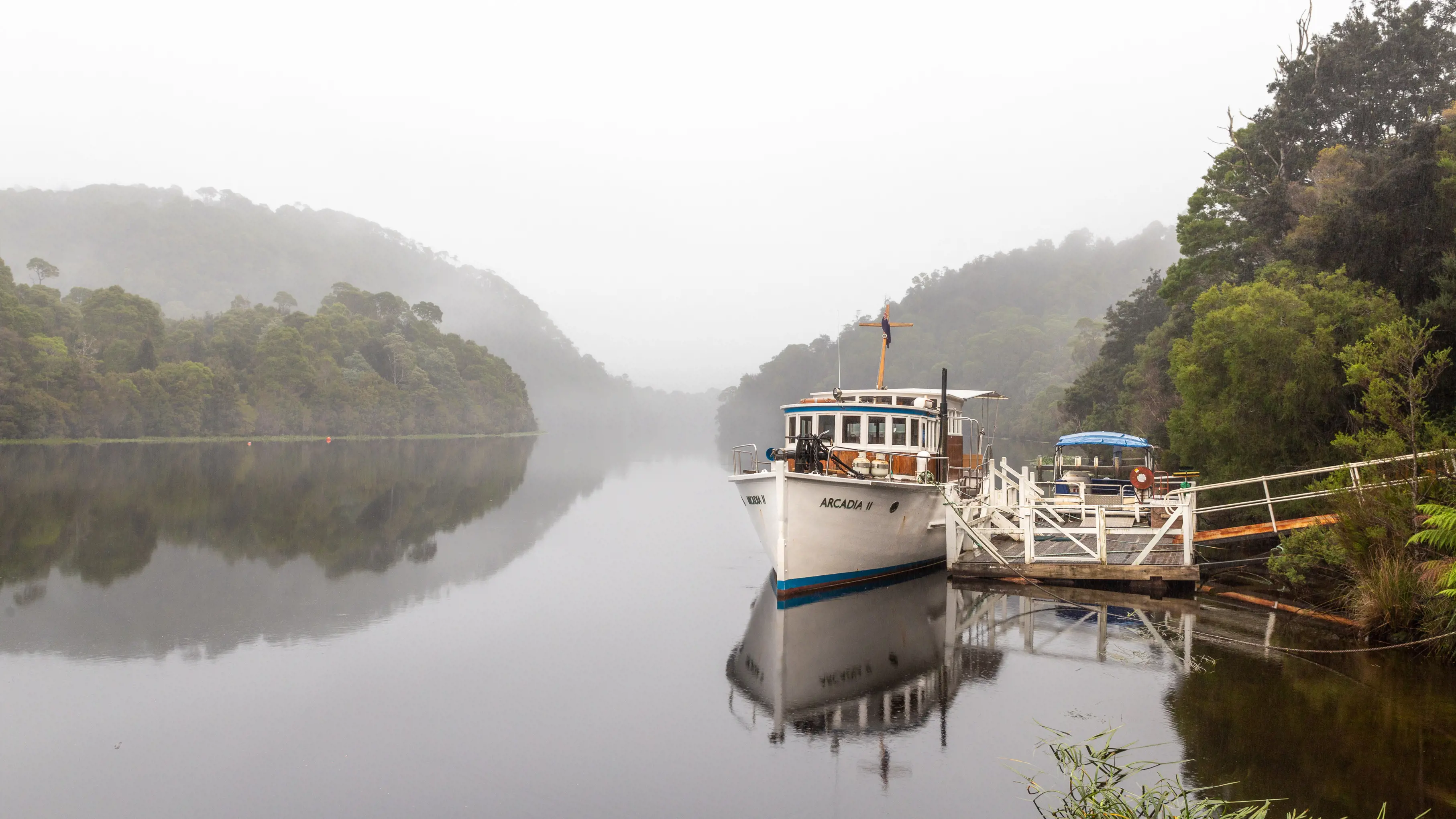 A fishing floating on the glossy Pieman River.