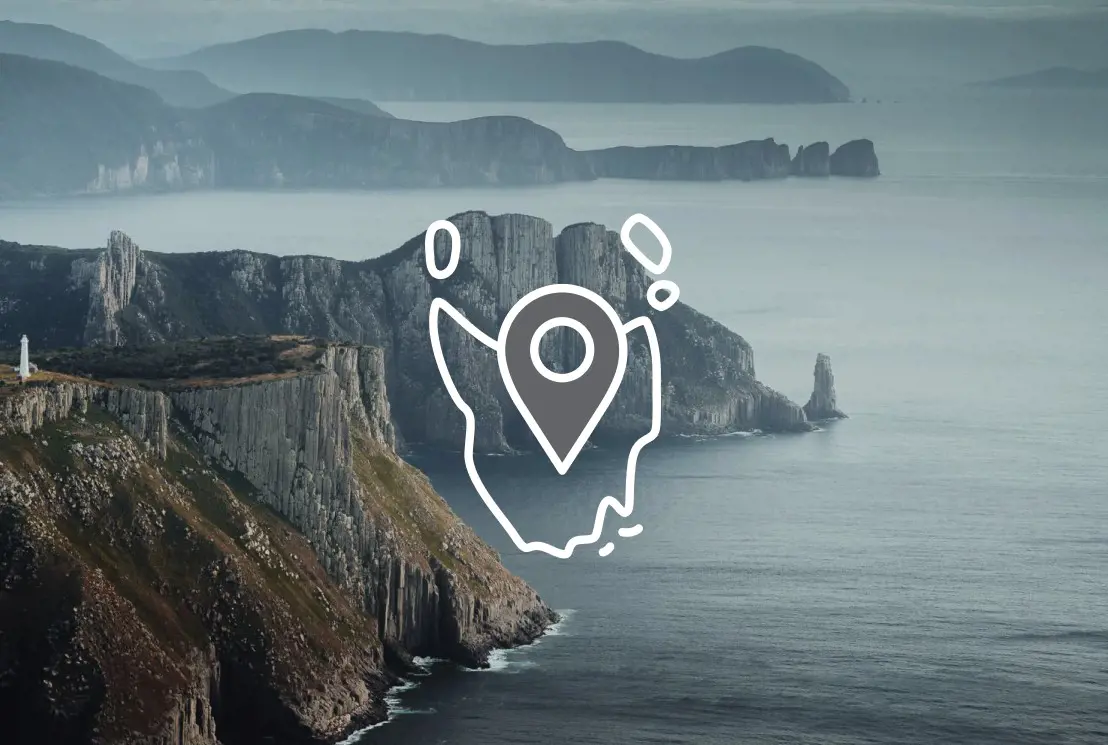 Tall, jagged cliffs jutting out over the ocean. Overlaid is an icon of the outline of Tasmania with a map pin.